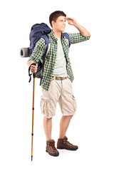 full length portrait of a hiker with backpack looking