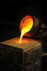 Foundry - molten metal poured from ladle into mould - lost wax