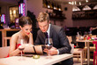© luckybusiness - Smiling couple decide what to order