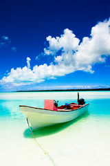 Wall Mural - Peaceful calm setting of a boat in a tropical lagoon