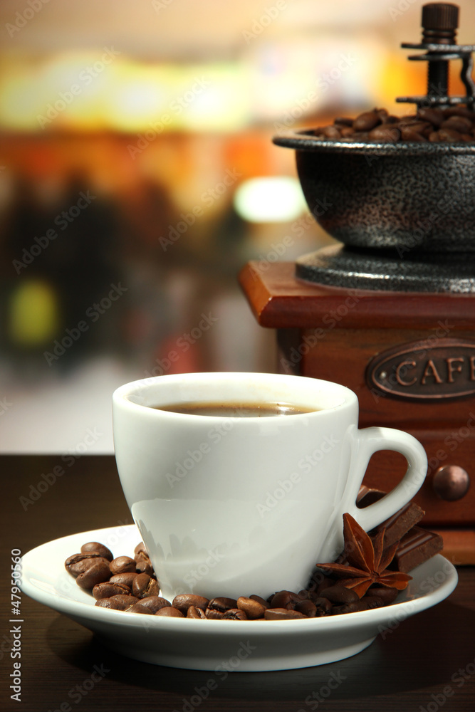 cup of coffee, grinder and coffee beans in cafe
