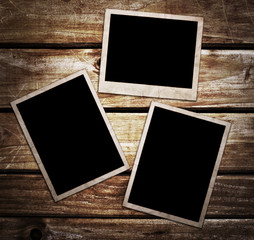 Aged photo frames on wood background