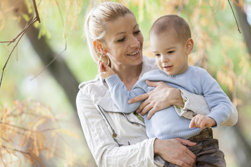 Wall Mural - Mother and boy in the autumn forest