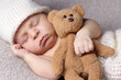 sleeping baby with teddy bear