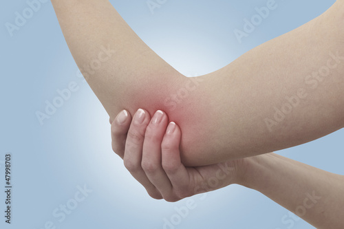 Fotografía Acute pain in a woman elbow. Female holding hand to spot of elbo