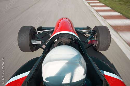 Fototapeta na wymiar Red bolide driving at high speed in circuit.Camera on board