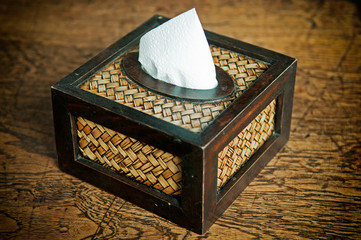 Tissue paper box made by basketry bamboo on old wooden table