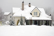 House And Its Garden Under Snow In Winter