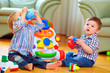 © Olesia Bilkei - cute funny baby boys playing with toys at home