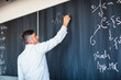 © lightpoet - Senior chemistry professor writing on the board