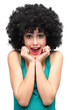 © pikselstock - Excited woman wearing afro wig