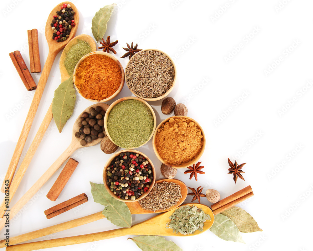 wooden bowls and spoons with spices isolated on white