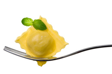 ravioli pasta parcel and basil garnish on fork white background