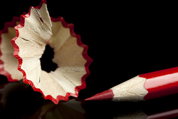 sharpened red pencil and shavings