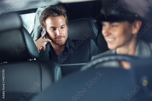 Businessman in limousine chauffeur driving Poster Mural XXL