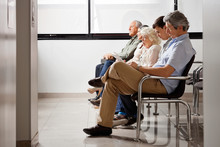 People Waiting For Doctor In Hospital Lobby