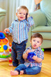 © Olesia Bilkei - funny baby toddlers playing at home