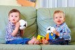 © Olesia Bilkei - cute little baby boys playing toys at home