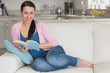 © WavebreakmediaMicro - Young reading woman in the living room