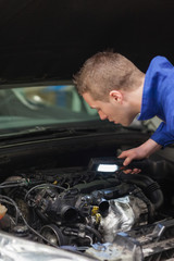 Poster - Repairman examining car engine