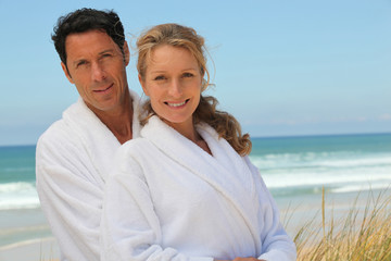 Wall Mural - couple in robes on the beach