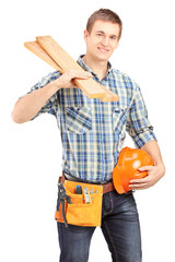 Canvas Print - Smiling carpenter holding a helmet and sills