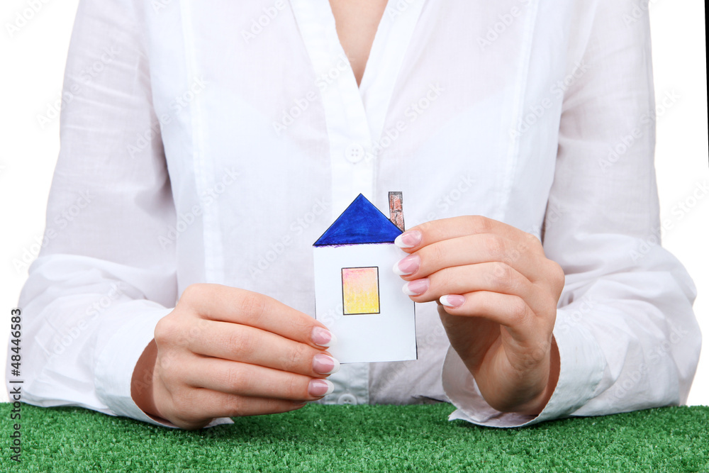 concept: woman hands with paper house, close up