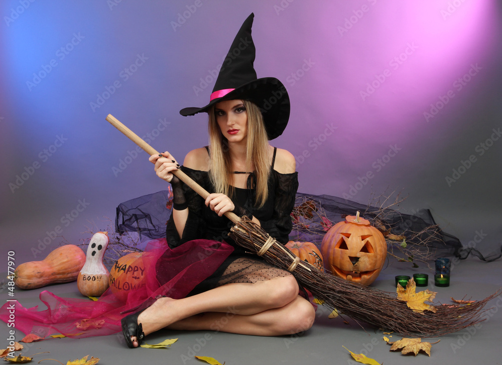 Halloween witch with  broom on color background