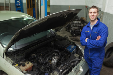 Poster - Confident repairman by car with open hood