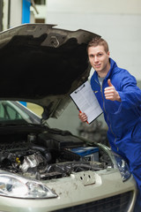 Poster - Mechanic by car showing thumbs up