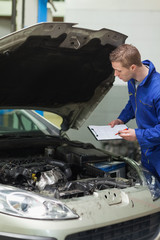 Poster - Mechanic checking car engine