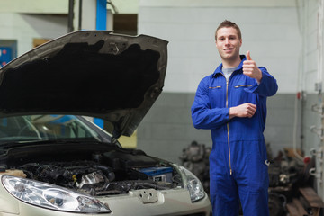 Poster - Mechanic by car giving thumbs up gesture