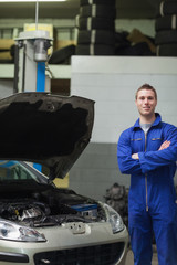 Poster - Happy mechanic standing by car with open hood