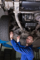 Poster - Happy mechanic under car