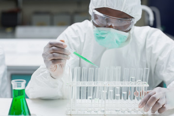 Poster - Chemist filling test tubes with green liquid