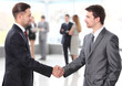 © opolja - business people shaking hands over a deal