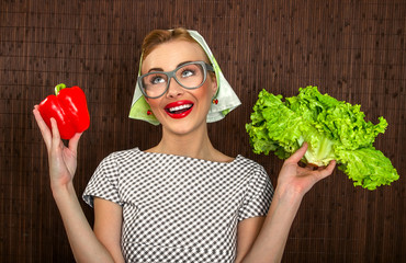 Funny woman cook holding salad and sweet pepper, close up