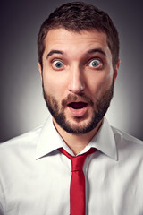 Poster - surprised man over grey background