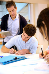 Wall Mural - Teacher watching students writing exam