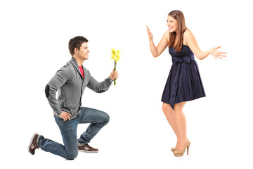 Wall Mural - A male kneeling with flowers and his excited girlfriend