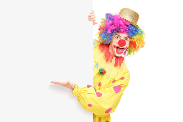 Poster - A funny circus clown posing behind a panel and gesturing