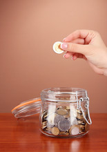 Saving, Female Hand Putting A Coin Into Glass Bottle,
