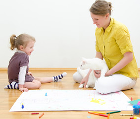 Young woman and little girl drawing together