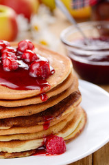 delicious pancakes with raspberries on the wooden kitchen tabl