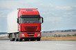 © Kadmy - Red lorry with white trailer over blue sky