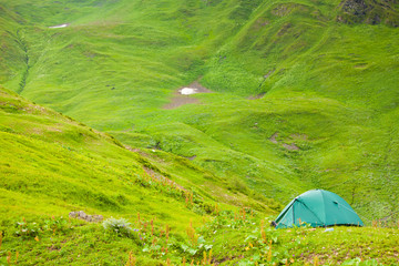 Canvas Print - Green tent on meadow between mountains, Georgia