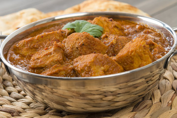 Wall Mural - Goan Pork Vindaloo - Indian pork curry with naan bread