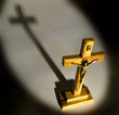 Crucifix with spotlight lighting casting shadow