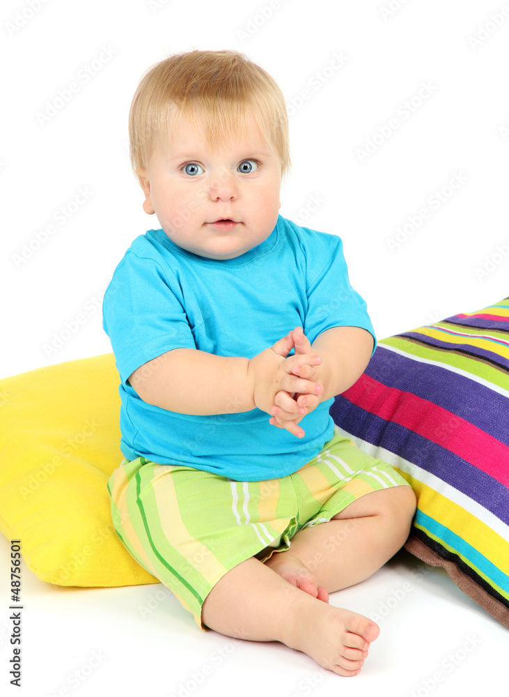 Little boy and color pillows, isolated on white