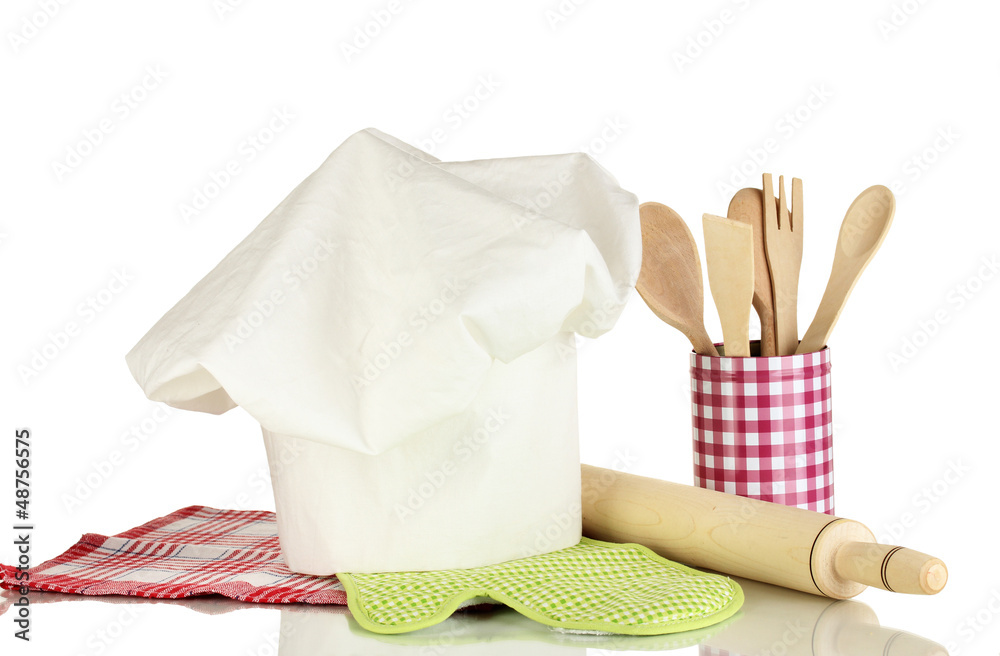 Chef's hat with spoons and battledore isolated on white